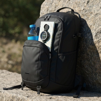Close-up of a hiking backpack with essential gear, natural lighting